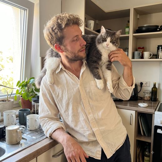 Daniel, founder of Happy Snoot, holding his cat