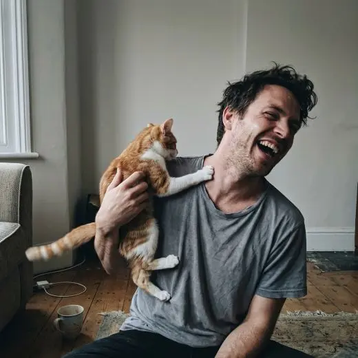 Our founder holding his cat