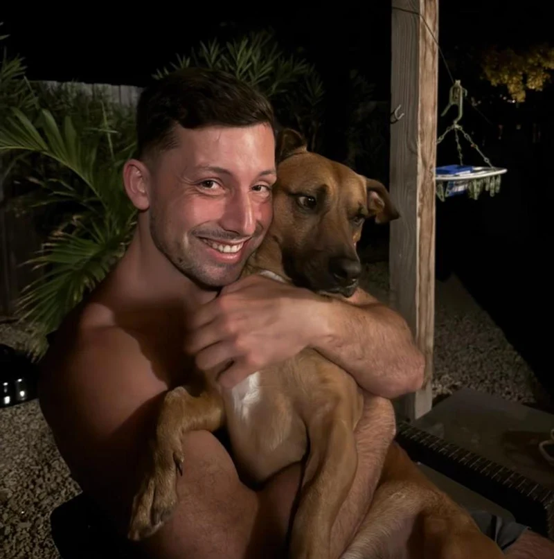 Our founder holding his dog